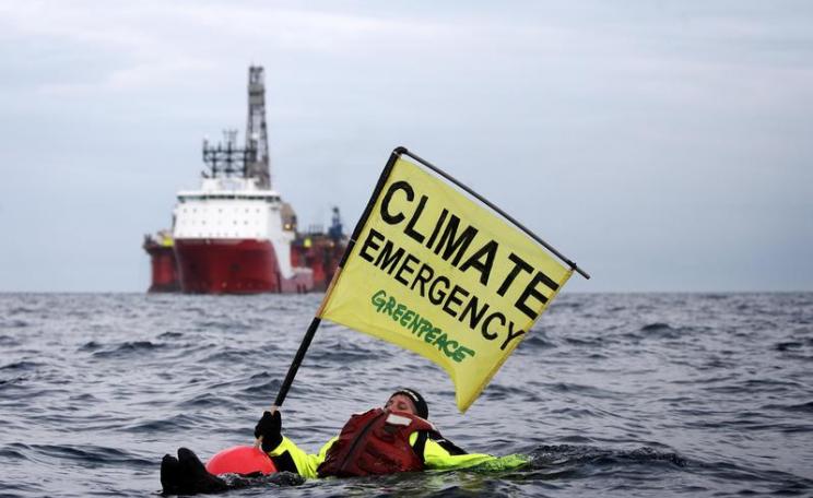 Swimmer in front of BP Oil Rig in North Sea