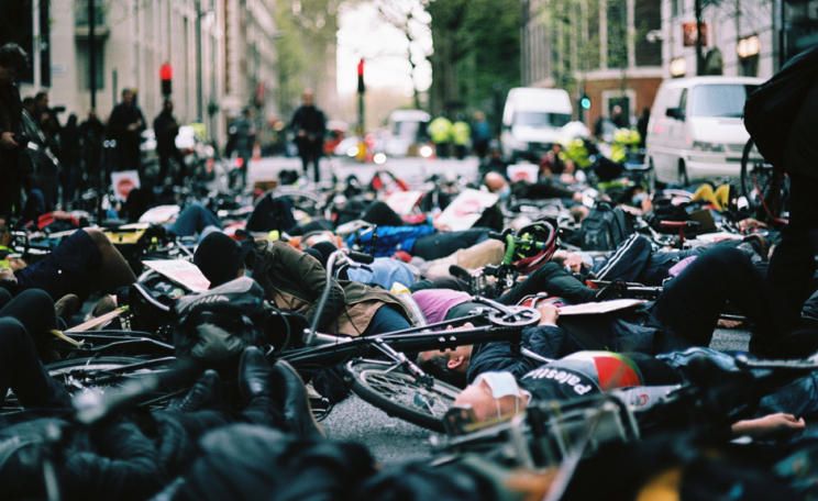 Photograph of cyclists laying in the road at a Stop Killing Cyclists protest